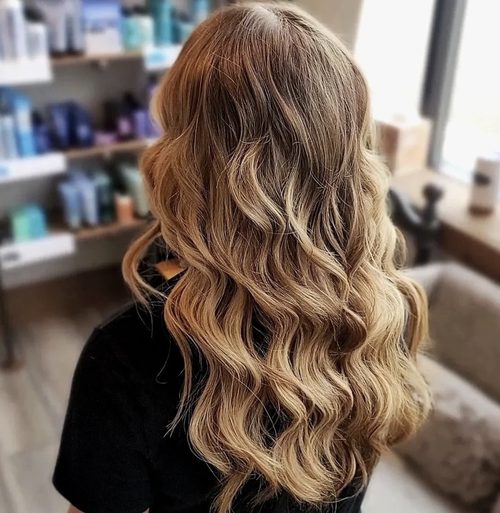 Lived-in blonde balayage in long waves